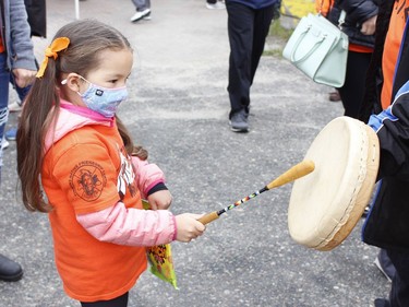 Participants of all ages took part in the annual Orange Shirt Day walk in Timmins on Thursday morning. Here, Genni Hookimawillellene, 4, is given the opportunity to beat on a hand drum.

RICHA BHOSALE/The Daily Press