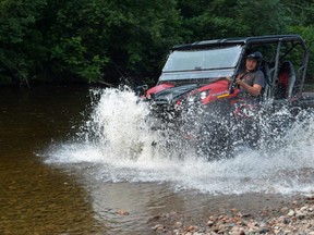 Co-organizer Allan MacDonald makes it through some water during the Harvey Perron Memorial Charity ATV Poker Ride on Saurday morning.