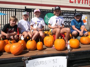 A group of local children and their families are selling pumpkins to raise money for Childcan, which supports families with children diagnosed with cancer. From left are Seth Hodgins, Hazel Kamenar, Payton Ens, Grace Kamenar and Cole Hodgins. The sale continues Saturday, Sept. 25 (11-4) in front of Canadian Tire Tillsonburg. (Chris Abbott/Norfolk and Tillsonburg News)