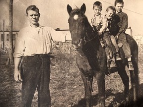 From left to right: Royal Canadian Navy veteran Doug McNaughton, Brownie, and his sons: eight-year-old Pat, five-year-old Tim, and 10-year-old Mike. This photo was taken in 1956 in the backyard of the McNaughton family home at 659 Murray St., Wallaceburg. In the background is the recently-constructed (at the time the photo was taken) Holy Family School. Submitted by Mike McNaughton