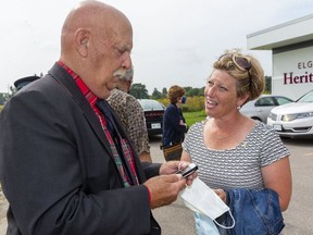 Middlesex-Elgin-London Conservative candidate Karen Vecchio talks to Duncan McPhail, the mayor of West Elgin about Vecchio's campaign plans for the day in West Elgin after the raising the childhood cancer gold ribbon flag in Elgin County last week. (Mike Hensen/Postmedia)