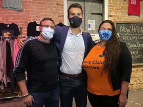 Liberal candidate David Bruno, left, Conservative Eric Melillo, middle, and NDP candidate Janine Seymour pose for a photo at Bob's Burger Bar following Melillo's win in the federal election on Monday, Sept. 20.