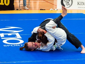 Hanover's Megan Kuntz (white Gi) applies a triangle choke during her division's final match at the 2021 GTA Classic at the Markham Pan Am Centre. Kuntz, one of 11 athletes from Kilian Academy in Owen Sound represented at the Brazilian Jiu-Jitsu tournament this past weekend, won a silver medal. Photo supplied.