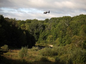 An Ontario Provincial Police helicopter hovers low over the Bighead River in Meaford Friday morning near the Trout Hollow Trail entrance across from Beautiful Joe Park as the Grey Bruce OPP search for a missing 25-year-old man. Greg Cowan/The Sun Times