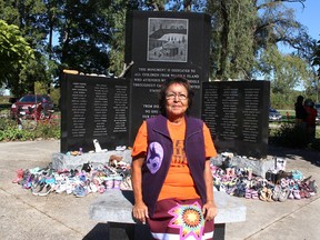Residential school survivor Beverly Williams sits in front of a monument dedicated to all children from the Walpole Island First Nation who attended residential schools in Canada and the United States. Ellwood Shreve/Postmedia Network