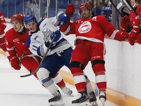 Landon McCallum, left, of the Sudbury Wolves, upends Robert Calisti, of the Soo Greyhounds, during OHL exhibition action at the Sudbury Community Arena in Sudbury, Ont. on Friday October 1, 2021.