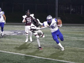 St Mary's Knights defender Jaiden Trudeau grabs the jersey of Superior Heights running back Lucas Pacione during the second quarter of high-school football action at the Sergeant John Faught Fieldhouse on Friday night. The Knights picked up a 3-0 win over the Steelhawks in senior ball action.