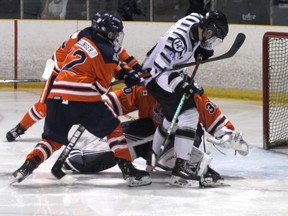 Soo Thunderbirds goalie Noah Metivier searches for the puck in a tangle of legs and skates in Northern Ontario Junior Hockey League action at the John Rhodes Community Centre. Metivier turned aside 32 shots as the Thunderbirds picked up a 5-0 win over the Espanola Express on Saturday night.