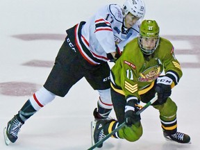 Liam Arnsby of the North Bay Battalion works against the Owen Sound Attack's Lorenzo Bonaiuto in Ontario Hockey League exhibition action, Saturday. The teams wrapped up their preseason schedules before the regular season starts Thursday night. Sean Ryan Photo