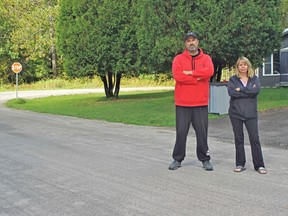 Todd McGowan, left, and Nicole Longworth say dump trucks getting to a gravel pit near their homes have disrupted their quality of life in Powassan by creating extreme dust situations and loud noise. Longworth's home, pictured, at 80 McCharles Line is constantly covered in dust. McGowan's home across the street also gets hit with dust from the trucks rumbling down the narrow road. Rocco Frangione Photo
