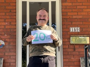 L'Arche Stratford resident and Be Belong Become Campaign ambassador Cory Maschke shows off his goal for this month's Walk 'n' Roll virtual fundraiser, which is raising money for renovations at the new L'Arche Hub at 426 Britannia Street. Submitted photo