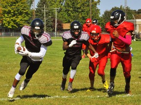 Taye Lovell of the Holy Trinity Titans, left, scored a touchdown in Holy Trinity’s 23-0 win over the Waterford Wolves Friday at Waterford District High School. – Monte Sonnenberg