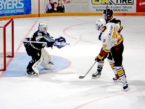 Gold Miners goalie Nick Alvarez makes a save off the stick of Timmins Rock forward Dylan McElhinny during the second period of Friday night’s NOJHL contest at the Joe Mavrinac Community Complex in Kirkland Lake. While McElhinny was foiled on this play, he beat Alvarez for his first NOJHL in the third period of the contest, as the Rock went on to dump the Gold Miners 6-2. BRAD SHERRATT/POSTMEDIA NETWORK