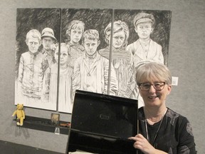 Karen Bachmann, director/curator of the Timmins Museum, displays the box of old letters collected by Essie Smith which inspired her grand-daughter, Elliot Lake artist Linda Finn, to produce the 34 pieces that are now on display at the Timmins Museum. The exhibition, entitled The War Letters, is on display in the museums grey gallery until Nov. 7.

RON GRECH/The Daily Press