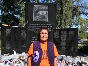 Residential school survivor Beverly Williams sits in front of a monument dedicated to all children from the Walpole Island First Nation who attended residential schools in Canada and the United States. Ellwood Shreve/Postmedia Network