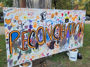 People took time to sign a reconciliation poster set up at Simplot Park for truth and Reconciliation Day in Portage la Prairie. (Aaron Wilgosh/Postmedia)