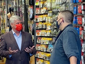 Sault MP Terry Sheehan spakes to Joe's Sports and Surplus co-owner Steve Meating about a new Shop Local program the federal govenment is funding.  Elaine Della-Mattia
