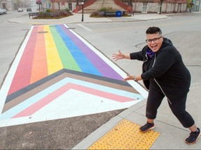Sirkel Foods owner Kelly Ballantyne enjoys Stratford’s first progress pride crosswalk. Ballantyne advocated for the crosswalk, completed near city hall over two days this week, with local group Stratford-Perth Pride. A number of community partners, including local companies Magest Building Systems Limited and Powerhouse Painting, helped make the project a reality. Chris Montanini/Stratford Beacon Herald