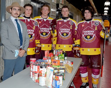 The Timmins Majors collected donations for the South Porcupine Food Bank during Saturday night’s intersquad game at the McIntyre Arena. In addition to a table full of non-perishable food items, the team collected $150 in cash. Posing with the items collected during the first intermission are, from left, coach Kevin Walker, assistant captain Blake Ferron, assistant captain Ray Durocher, captain Bradley Moore and assistant captain Tristan Bouchard. THOMAS PERRY/THE DAILY PRESS