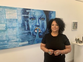 Fran Hanover stands in front of a piece from her art show titled SPIT, The Art of Disclosure, which opened Saturday at the Alex Dufresne Gallery in Callander. The show captures the artist’s search for her ethnic roots, which leads to a medical miracle. Jennifer Hamilton-McCharles/The Nugget