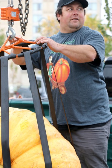 Chris McGrath helps to prepare a pumpkin to be weighed at Algoma Farmer's Market's annual giant pumpkin festival at Roberta Bondar Pavilion Tent and Park in Sault Ste. Marie, Ont., on Saturday, Oct. 9, 2021. (BRIAN KELLY/THE SAULT STAR/POSTMEDIA NETWORK)