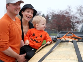 Kieran O'Neill, Carly Brown O'Neill and their son, Kelton, celebrate their win with a 770-pound pumkin during Algoma Farmer's Market's giant pumpkin weigh-off near Roberta Bondar Pavilion on Saturday, Oct. 9, 2021 in Sault Ste. Marie, Ont. (BRIAN KELLY/THE SAULT STAR/POSTMEDIA NETWORK)