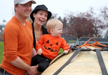Kieran O'Neill, Carly Brown O'Neill and their son, Kelton, celebrate their win with a 770-pound pumkin during Algoma Farmer's Market's giant pumpkin weigh-off near Roberta Bondar Pavilion on Saturday, Oct. 9, 2021 in Sault Ste. Marie, Ont. (BRIAN KELLY/THE SAULT STAR/POSTMEDIA NETWORK)