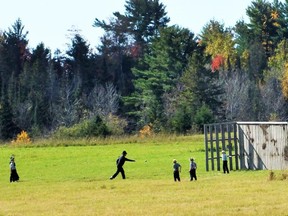 Children and their teacher enjoy a baseball game on lands that will house the future Mennonite School House.