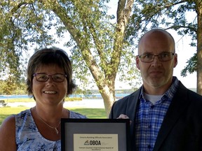 Michele Barr,  recently retired Director of Building and Planning and CBO for the Municipality of Kincardine accepts the Yaman Uzumeri International Award of Excellence for her  contribution and devotion to the building industry from Matt Farrell, Past President of the OBOA and CBO of Huron-Kinloss. SUBMITTED