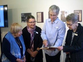Kaarina Tulisalo, left, Bonnie Roynon, Nat Brunette and Doris Toswell look at some of the early minutes of the North Bay chapter of the Canadian Federation of University Women, Wednesday, at the North Bay Museum.
PJ Wilson/The Nugget