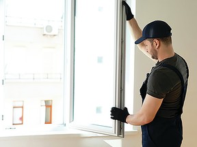 A man installing high effeciency windows. (Metro Creative Services)