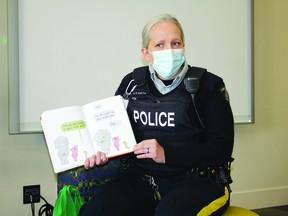 Leduc RCMP Const. Cheri-Lee Smith reads to youngsters at the Leduc Library Oct. 7 as part of the R.E.A.D. with the RCMP Literacy Program that aims to foster a love of reading. (Ted Murphy)