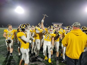 Korah Colts player Kohle Kennedy (#27) holds up the league championship trophy, handed out Friday night after the Colts beat the Superior Heights Steelhawks to win thier fourth consecutive league title. The Colts close out the regular season when they play the St. Mary's Knights at the Sargeant John Faught Fieldhouse this Friday night. Kickoff is set for 7:30 p.m.