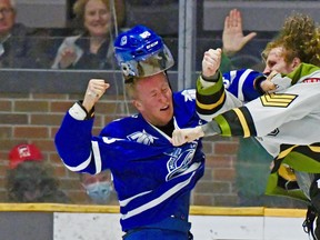 The North Bay Battalion's Josh Currie punishes Ole Bjorgvik-Holm of the Mississauga Steelheads in Ontario Hockey League action, Friday night. Each got a fighting major, and Mississauga's Norwegian import drew a roughing minor for the duel that followed Mitchell Russell's first-period goal for the Troops. Sean Ryan Photo