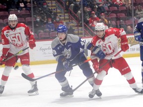 Soo Greyhound forwards Landen Hookey (left) and Marco Mignosa (right) sandwich Sudbury Wolves defenceman Payton Robinson during an Ontario Hockey League game at the GFL Memorial Gardens on Oct.9. The Greyhounds improved to 2-0 on their three-game road trip following a 4-2 road win over the Barrie Colts on Friday night.