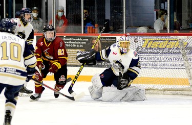 Timmins Rock forward Liam Wells watches as the puck flies past the head of Kirkland Lake Gold Miners goalie Glen Crandall after the point shot he deflected bounced off the post during the first period of Sunday afternoon’s NOJHL contest at the McIntyre Arena. The Rock went on to defeat the Gold Miners 4-1 and strengthen their hold on top spot on the NOJHL’s overall standings. THOMAS PERRY/THE DAILY PRESS