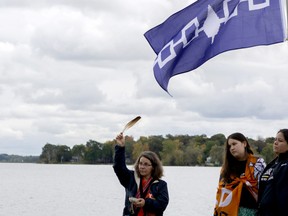 Clarice Gervais, left, Kiki Olivier and Shannon Olivier stand at the foot of Stone Street South in Gananoque during the dedication of the First Peoples Park of the Thousand Islands. The dedication happened on the final day of the three-day First Peoples Performing Arts Festival.(JESSICA MUNRO/Local Journalism Initiative Reporter)