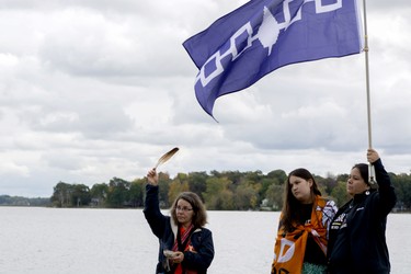 Clarice Gervais, left, Kiki Olivier and Shannon Olivier stand at the foot of Stone Street South in Gananoque during the dedication of the First Peoples Park of the Thousand Islands. The dedication happened on the final day of the three-day First Peoples Performing Arts Festival. (JESSICA MUNRO/Local Journalism Initiative)