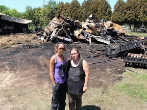 Lauren Edward, left, founder of Charlotte's Freedom Farm, and Christine Rettig, a former staffer who rescued several animals, stand in front of a barn that was destroyed in a fire at the Brook Line facility near Chatham just before midnight on July 1, 2020. Rettig was charged with two counts of arson by Chatham-Kent police on Saturday, one count in connection to the July 2020 fire and other count in connection to a trailer fire on the property on June 20. (Ellwood Shreve/Chatham Daily News)