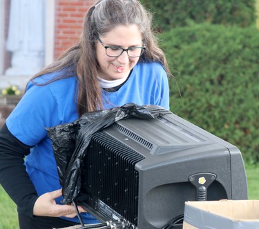 Franceline Burton protects sound equipment during a rosary rally at Our Lady of Good Counsel Catholic Church on Saturday, Oct. 16, 2021 in Sault Ste. Marie, Ont. (BRIAN KELLY/THE SAULT STAR/POSTMEDIA NETWORK)
