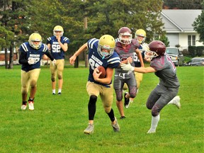 Running back Foster Scheers of the Delhi Raiders breaks through into the defensive secondary of the Pauline Johnson Thunderbirds Friday during regular season action in the Brant-Norfolk Varsity Football League. The Thunderbirds scored a surprise win en route to their first victory of the season, defeating the 3-0 Raiders 27-20 at Delhi District Secondary School. – Monte Sonnenberg