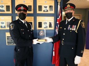 Det.-Const. Ryan Hutton receives the Sergeant Richard McDonald Memorial Award from Greater Sudbury Police Chief Paul Pedersen. The award recognizes an attitude that inspires colleagues and fosters team spirit.