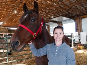 Angie Hurst, founder of Out of the Ashes large animal rescue, with one of the 38 horses living at the not-for-profit sanctuary in Sebringville.  (Chris Montanini/Stratford Beacon Herald)