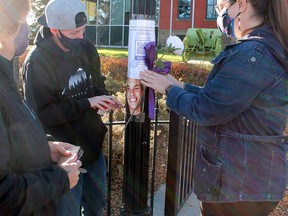 (l-r) Rhonda Watt, Kat Majewski and Edmonton Zone Opioid Poisoning Committee’s Rural representative Dr. Cayla Gilbert marked Opioid Memorial Weekend with a white rose, purple ribbon and a photo of Watt’s deceased son Erik Garuthers on a light pole outside Wetaskiwin City Hall Saturday.