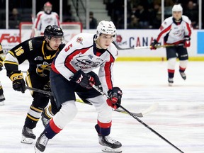 Windsor Spitfires' Dylan Robinson (5) is chased by Sarnia Sting's Theo Hill (16) in the second period at Progressive Auto Sales Arena in Sarnia, Ont., on Sunday, Jan. 26, 2020.