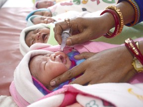 An Indian health official administers polio vaccine drops to new born babies at a government hospital in Agartala on January 28, 2018. Across the country children of less than five years old will receive polio vaccine drops as part of a program to eradicate polio virus. / AFP PHOTO / Arindam DEYARINDAM DEY/AFP/Getty Images