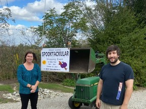 West Elgin Coun. Angela Cammaert and vendor Josh Zoboki put up a sign for the upcoming West Lorne Spooktacular Shopping Event, which will take place in Miller Park on Saturday, Oct. 23. Handout/Postmedia Network