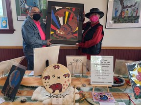 Zoey Wood-Salomon and her husband, Jim, display a sample of Wood-Salomon’s work during the recent In the Spirit of the Land art show, in Richards Landing. PATRICIA BAKER