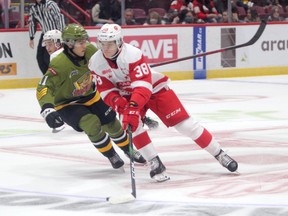 Jordan D’Intino of the Soo Greyhounds rags the puck as North Bay Battalion forward Liam Arnsby tracks from behind. Rory Kerins scored a hat-trick as the Hounds picked up an 8-5 win over the Battalion in Ontario Hockey League action at the GFL Memorial Gardens on Friday night.