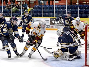 Kirkland Lake goalie Zachary Reddy smothers the puck before Timmins Rock forward Nicolas Pigeon can pounce on a rebound during Wednesday night’s NOJHL contest at the McIntyre Arena. The Rock went on to defeat the Gold Miners 4-1, completing a sweep of the home-and-home series that saw them win by an identical score on home ice Sunday afternoon. ALLYSON DEMERS/FOR NOJHL NETWORK